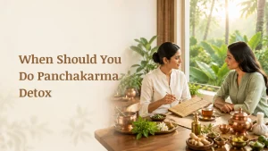 When Should You Do Panchakarma Detox consultation with Ayurvedic practitioner discussing personalized wellness and seasonal detox plan in a premium healing retreat.